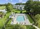 Aerial view of a community pool area with a pool house and lounge chairs at 556 White River Dr. # 44F, Myrtle Beach, SC 29579