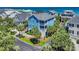 Stunning aerial view of blue beach home, showcasing its proximity to the ocean and lush surroundings at 573 S Dunes Dr., Pawleys Island, SC 29585