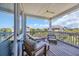 Relaxing covered balcony with comfortable seating, offering views of the neighborhood and blue sky at 573 S Dunes Dr., Pawleys Island, SC 29585