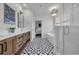 Elegant bathroom with dual vanity, patterned tile, soaking tub, and glass-enclosed shower, with a view to the bedroom at 573 S Dunes Dr., Pawleys Island, SC 29585