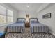 Bedroom features two twin beds, striped bedding, and natural light at 573 S Dunes Dr., Pawleys Island, SC 29585