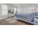 Bright bedroom features a TV, boho rug, and closet storage at 573 S Dunes Dr., Pawleys Island, SC 29585
