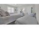Shared bedroom boasts two twin beds and neutral coastal decor at 573 S Dunes Dr., Pawleys Island, SC 29585