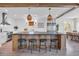 Modern kitchen island with bar stool seating features stylish pendants and a chef-grade range at 573 S Dunes Dr., Pawleys Island, SC 29585