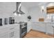 Bright kitchen features stainless steel appliances, white cabinets, and an inviting atmosphere at 573 S Dunes Dr., Pawleys Island, SC 29585
