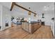 Open concept kitchen with island seating, seamlessly connects to a living area with a fireplace at 573 S Dunes Dr., Pawleys Island, SC 29585