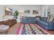 Relaxing living room with blue sectional, colorful rug, and flatscreen tv at 573 S Dunes Dr., Pawleys Island, SC 29585