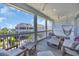Relaxing covered porch with comfortable seating and a view of the surrounding neighborhood and ocean at 573 S Dunes Dr., Pawleys Island, SC 29585