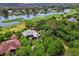 Stunning aerial view of a luxury home overlooking a golf course and waterfront community at 58 Swan Point Trail, Georgetown, SC 29440