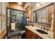 Bathroom featuring a granite countertop vanity, a glass enclosed shower with decorative tile and wood accents at 58 Swan Point Trail, Georgetown, SC 29440