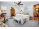 Traditional bedroom featuring wood paneling, a comfortable bed, and a glimpse of the ensuite bathroom at 58 Swan Point Trail, Georgetown, SC 29440
