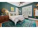 A beautifully styled bedroom with dark green walls, a bench, and coordinated textiles and décor accents at 58 Swan Point Trail, Georgetown, SC 29440
