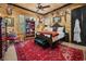 Rustic bedroom with wooden walls, a large patterned rug, a decorative hunting theme and a classic bed at 58 Swan Point Trail, Georgetown, SC 29440