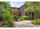 Beautiful exterior elevation showcasing the unique architectural details and lush surrounding landscape at 58 Swan Point Trail, Georgetown, SC 29440