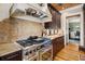 Gourmet kitchen with stainless steel appliances, custom cabinets, and a granite countertop at 58 Swan Point Trail, Georgetown, SC 29440