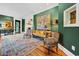 Sophisticated living room with plush seating, hardwood floors, and green walls at 58 Swan Point Trail, Georgetown, SC 29440