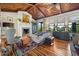 Bright living room with a cozy fireplace, wood floors, vaulted ceilings, and plenty of natural light at 58 Swan Point Trail, Georgetown, SC 29440