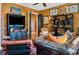 Inviting living room with wood paneling, comfortable leather seating, and eclectic decor at 58 Swan Point Trail, Georgetown, SC 29440