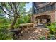 Spacious brick patio with outdoor table, grill and lush tropical landscaping at 58 Swan Point Trail, Georgetown, SC 29440