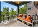 Cozy screened porch with comfortable orange bench and views of the surrounding landscape at 58 Swan Point Trail, Georgetown, SC 29440