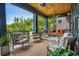 Relaxing screened porch featuring comfortable seating arrangements and wooded scenery at 58 Swan Point Trail, Georgetown, SC 29440