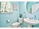 Charming powder room featuring a pedestal sink, decorative mirror, and a calming blue color scheme at 6095 Catalina Dr. # 714, North Myrtle Beach, SC 29582