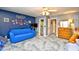 Spacious bedroom featuring a blue accent wall, dresser, television and comfortable blue couch at 6095 Catalina Dr. # 714, North Myrtle Beach, SC 29582