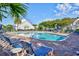Community pool with lounge chairs, umbrellas, and lush landscaping on a sunny day at 6095 Catalina Dr. # 714, North Myrtle Beach, SC 29582