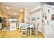 Bright dining area featuring modern light fixtures, breakfast bar, and a wood table for four at 6095 Catalina Dr. # 714, North Myrtle Beach, SC 29582