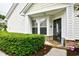 Charming entrance with a storm door, bay window, and neatly trimmed hedges under a covered area at 6095 Catalina Dr. # 714, North Myrtle Beach, SC 29582
