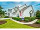 Inviting two-story home with manicured lawn, walkway, and flowerbeds under a beautiful blue sky at 6095 Catalina Dr. # 714, North Myrtle Beach, SC 29582