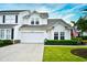 Charming two-story home with a well-manicured lawn, attached garage and beautiful blue skies above at 6095 Catalina Dr. # 714, North Myrtle Beach, SC 29582