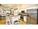 Open kitchen boasts white cabinets, stainless steel appliances, and a breakfast bar overlooking the living area at 6095 Catalina Dr. # 714, North Myrtle Beach, SC 29582