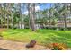 Picturesque backyard with a serene lake view and lush landscaping, creating a peaceful outdoor setting at 6434 Longwood Dr., Murrells Inlet, SC 29576