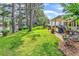 Beautiful backyard featuring well-manicured lawn and patio area for outdoor living and relaxing with a lake view at 6434 Longwood Dr., Murrells Inlet, SC 29576