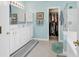 Bright bathroom showcases white cabinets, a tub, a shower, and a walk-in closet at 6434 Longwood Dr., Murrells Inlet, SC 29576