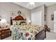 This cozy bedroom features a wooden bed frame, floral bedding, and neutral walls, creating a peaceful ambiance at 6434 Longwood Dr., Murrells Inlet, SC 29576