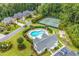 Aerial view showcasing the community pool, clubhouse, and tennis courts in a landscaped setting at 6434 Longwood Dr., Murrells Inlet, SC 29576