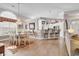 Open-concept dining area boasts a chandelier, bar seating, and seamless flow into the kitchen at 6434 Longwood Dr., Murrells Inlet, SC 29576