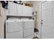 Practical laundry room equipped with a washer, dryer, and ample storage cabinets at 6434 Longwood Dr., Murrells Inlet, SC 29576