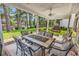 Outdoor patio area with a table and chairs, surrounded by lush greenery and a serene lake view at 6434 Longwood Dr., Murrells Inlet, SC 29576