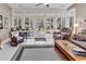 Bright sunroom filled with natural light, cozy seating, and views of the surrounding landscape at 6434 Longwood Dr., Murrells Inlet, SC 29576