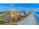 Aerial view showcasing a condo building with a beach nearby on a sunny day at 6900 N Ocean Blvd. # 840, Myrtle Beach, SC 29572