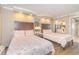 Bright bedroom featuring two beds with patterned coral bedding, wood floors, and mirrored closet at 6900 N Ocean Blvd. # 840, Myrtle Beach, SC 29572