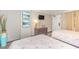 Bright bedroom with two beds featuring decorative bedding, artwork, and storage at 6900 N Ocean Blvd. # 840, Myrtle Beach, SC 29572
