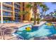 Community lazy river with clear water, palm trees, and building in the background at 6900 N Ocean Blvd. # 840, Myrtle Beach, SC 29572
