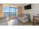Comfortable living room with ocean view balcony, sofas, and dining area at 6900 N Ocean Blvd. # 840, Myrtle Beach, SC 29572