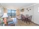 Inviting living room with balcony access, dining space, and neutral color palette at 6900 N Ocean Blvd. # 840, Myrtle Beach, SC 29572