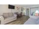 Cozy living room with sofas, dining table, modern TV, and warm lighting at 6900 N Ocean Blvd. # 840, Myrtle Beach, SC 29572
