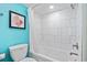 A tiled bath and shower with an attached commode at 7200 N Ocean Blvd. # 222, Myrtle Beach, SC 29572